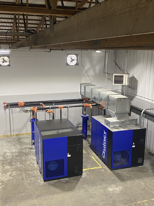Compressor units with overhead ducting and piping in a mechanical room