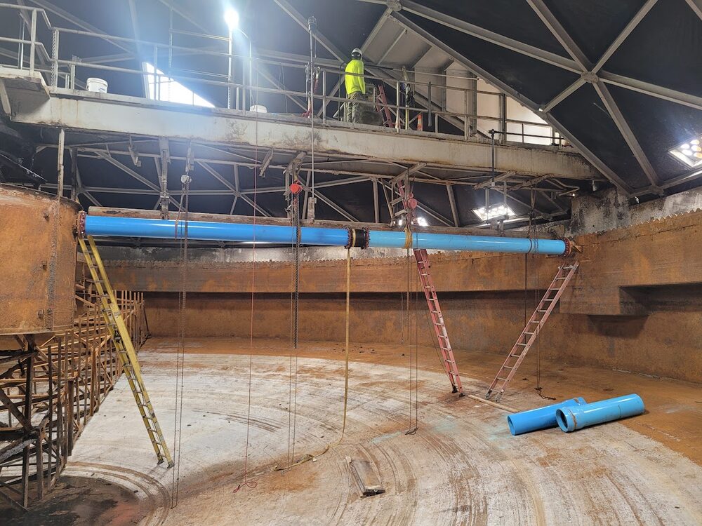 Pyramid crew member performing confined space maintenance work
