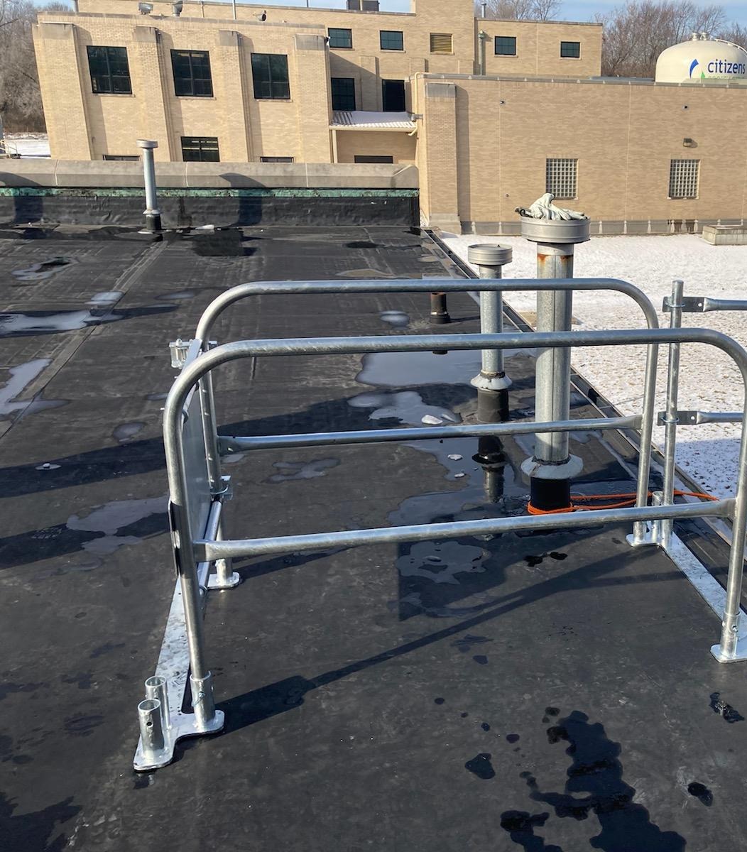 Citizens Energy facility rooftop with safety railing and access piping